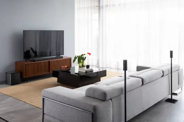 Surround 700 g1 Surround 700 in a room with sofa on a table beside a wall
